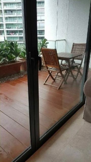 Balcony glass door and decking before cleaning